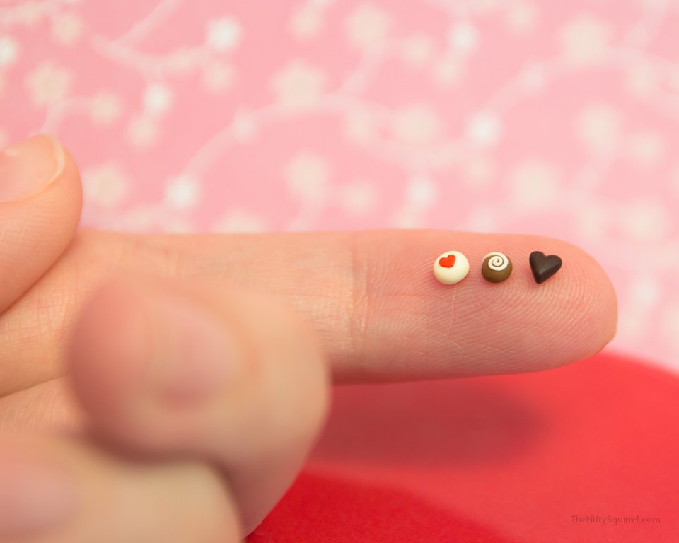 1:2 scale miniature chocolates on finger