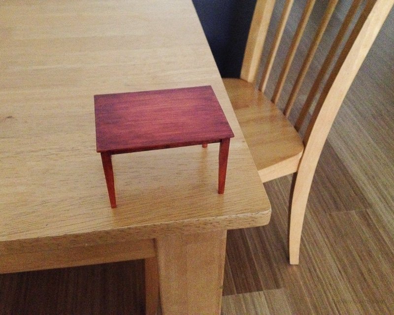 Miniature dining table on top of the original real table